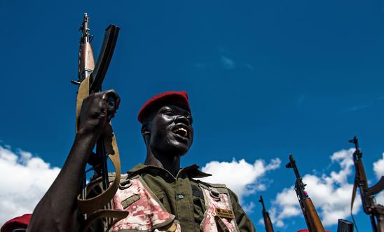A Sudan People's Liberation Army (SPLA) soldier holds up a gun at a containment site outside Juba on April 14, 2016 A Sudan People's Liberation Army (SPLA) soldier holds up a gun at a containment site outside Juba on April 14, 2016