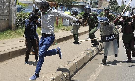 A protestor runs from anti-riot police on 26 September 2017 in Nairobi, during a demonstration to demand the removal of officials from national election oversight body A protestor runs from anti-riot police on 26 September 2017 in Nairobi, during a demonstration to demand the removal of officials from national election oversight body