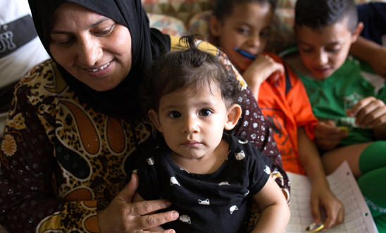 A smiling woman with her three children A smiling woman with her three children