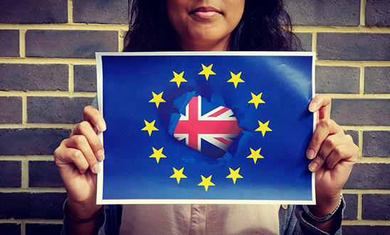 Young person holds up EU and Union Jack flag Young person holds up EU and Union Jack flag