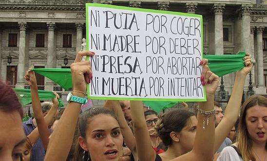Woman holding up placard in Argentina abortion protest Woman holding up placard in Argentina abortion protest