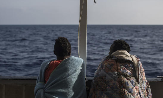 igrants look at the sea from the deck of the NGO Proactiva Open Arms boat on July 2, 2018 igrants look at the sea from the deck of the NGO Proactiva Open Arms boat on July 2, 2018