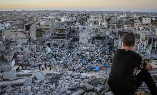 202472_a_palestinian_child_sits_above_the_ruins_of_his_ruined_home_0.jpg