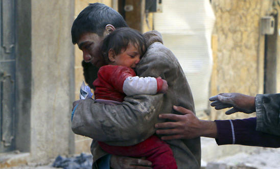 A boy holds his baby sister saved from rubble after an airstrike in Aleppo A boy holds his baby sister saved from rubble after an airstrike in Aleppo