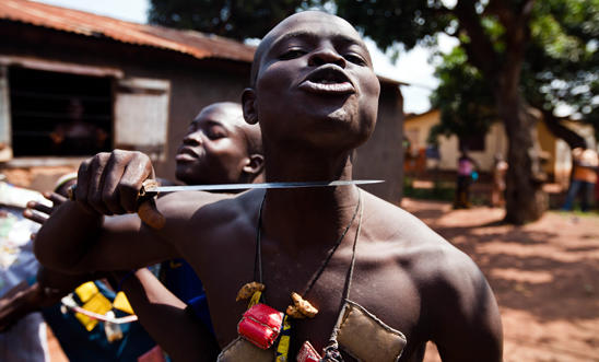 An Anti-balaka fighter holds a knife to his own throat An Anti-balaka fighter holds a knife to his own throat