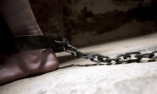Stock image of a prisoner in chains Stock image of a prisoner in chains