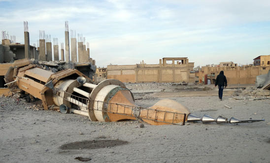 Raqqa: A man walks past a damaged mosque Raqqa: A man walks past a damaged mosque