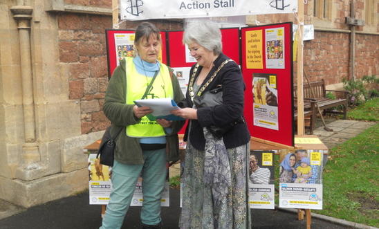 An Amnesty member with the mayor of Minehead in front of campaigning stall An Amnesty member with the mayor of Minehead in front of campaigning stall