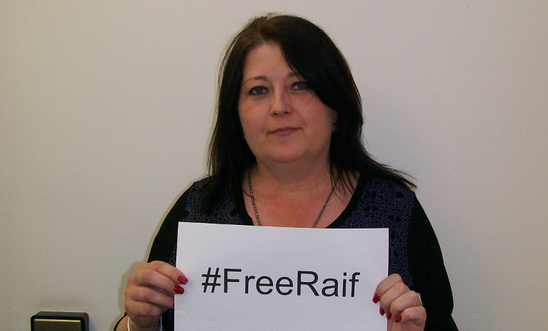 Local Group member of North Herts Group holding up FreeRaif hashtag Local Group member of North Herts Group holding up FreeRaif hashtag