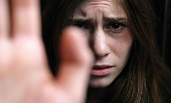 A woman holds her hand up to the camera A woman holds her hand up to the camera