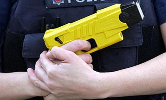 police officer holding Taser police officer holding Taser
