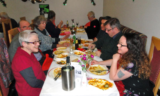 People around a table eating a meal People around a table eating a meal