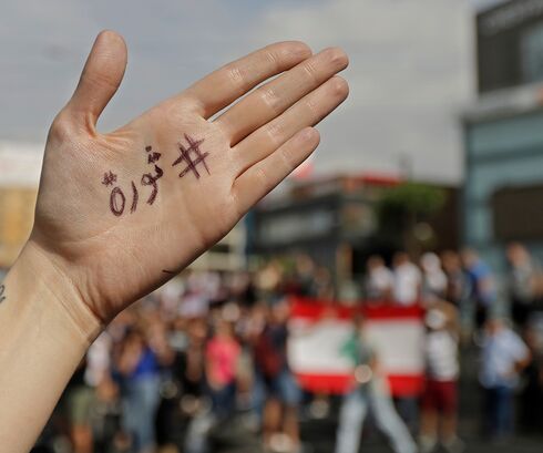 Beirut, Lebanon: A protester's hand baring the word, 'revolution'