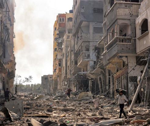 Damage of Israeli airstrikes in Gaza, with rubble of building fallen into a road.