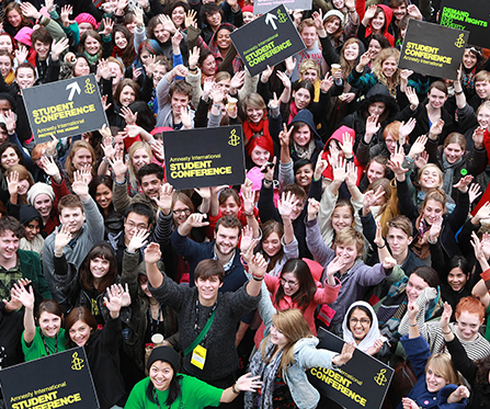 Large groups of people holding Amnesty signs