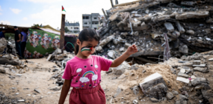  A Palestinian girl with a national flag painted on her face, plays amidst the rubble of buildings destroyed by Israeli bombardment of the Gaza Strip