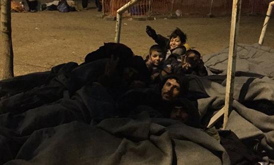 People sleeping outside a petrol station near the Greece/Macedonia border