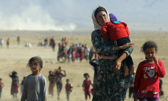 Displaced people from the minority Yazidi sect, fleeing violence from forces loyal to the Islamic State in Sinjar town, walking towards the Syrian border. © STRINGER/Reuters/Corbis