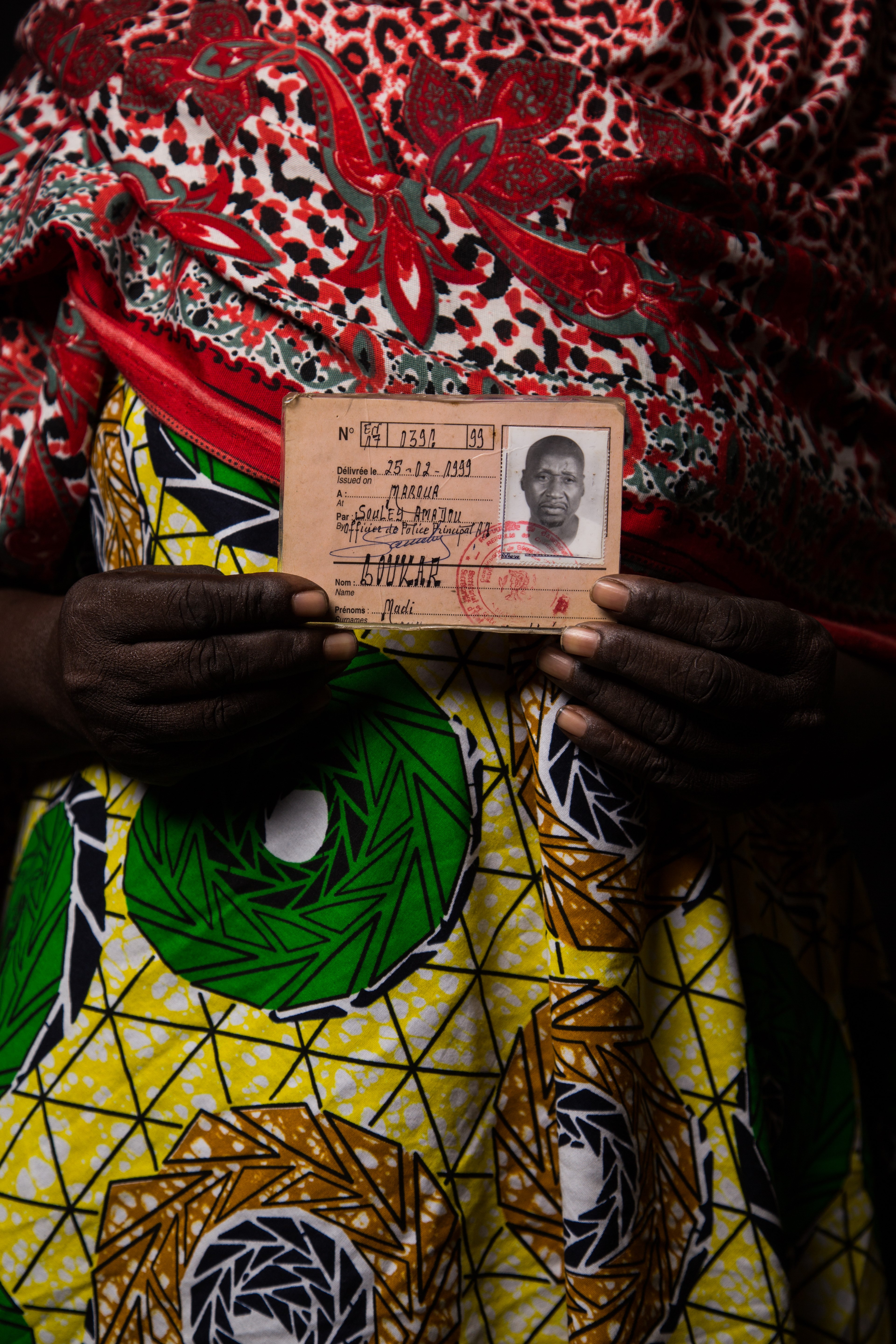 A woman showing the photo of her missing loved one