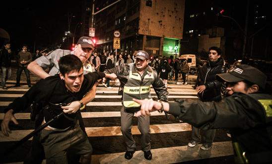 Police officers detaining a protester in São Paulo on 18 June 2013